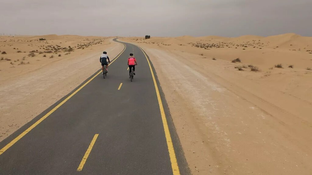 Cyclists riding on Al Qudra cycling track in Dubai desert