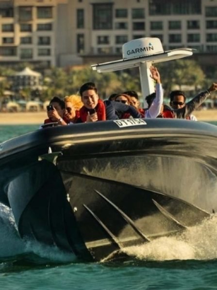Group enjoying a luxury boat tour in Dubai, with vibrant city skyline in the background, emphasizing adventure and leisure experiences offered by City Tour Dubai.